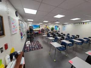 Inside Tavares HS Classroom showing interior finish with desks and white boards.