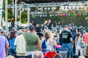 Large crowd watching a band perform on stage