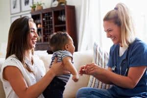 18006383 nurse with mother and child 300x200 1