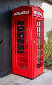 19426685 red phone booth 184x300 1