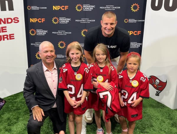 Gronk with Bucs COO Brian Ford and the kids at Cut and Color Funds the Cure (Rock Riley)