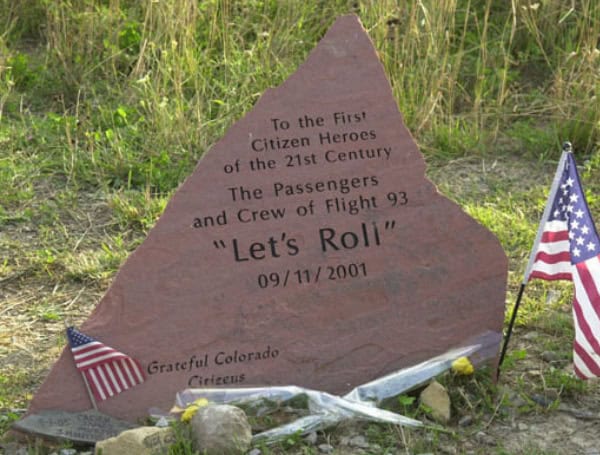 A marker at the temporary memorial, near Shanksville, PA, honors the passengers and crew of Flight 93, hijacked on September 11, 2001. (National Archives)