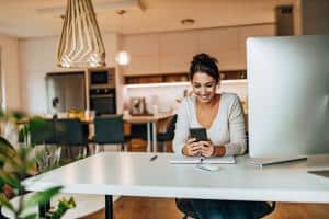 woman using phone in her home